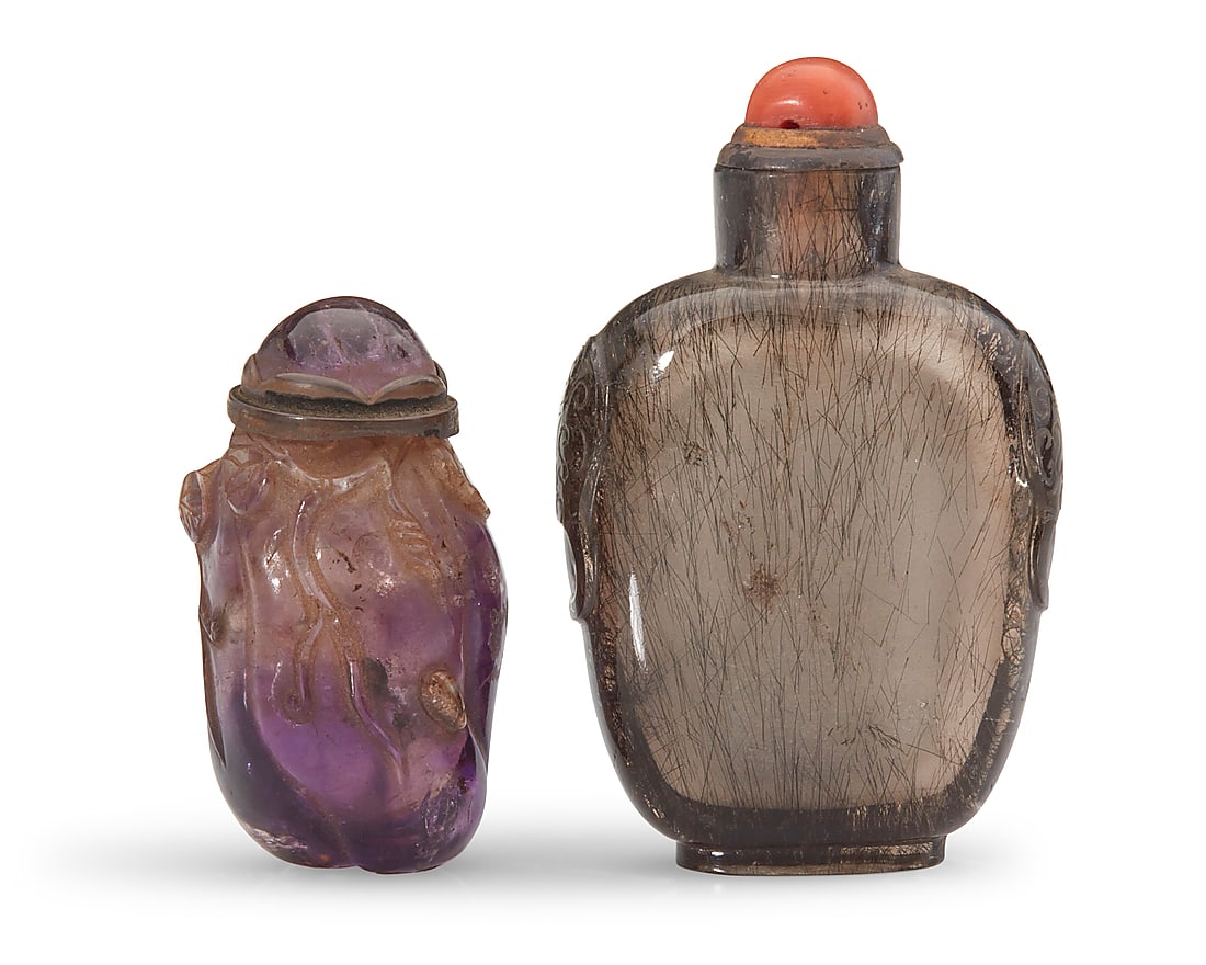 Two Chinese carved quartz snuff bottles: Two Chinese carved quartz snuff bottles Qing Dynasty (1644-1912) or later Comprising one gourd-form amethyst bottle carved with foliate motifs, and one rutilated smoky quartz bottle 2 pieces Amethyst: