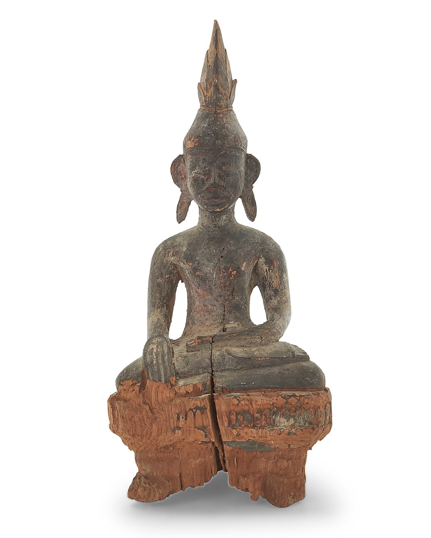 A Laotian carved wood Buddha: A Laotian carved wood Buddha Late 19th/early 20th century Depicted with ushnisha flame and hands in bhumisparsha mudra 24.5" H x 11.25" W x 8.75" D
