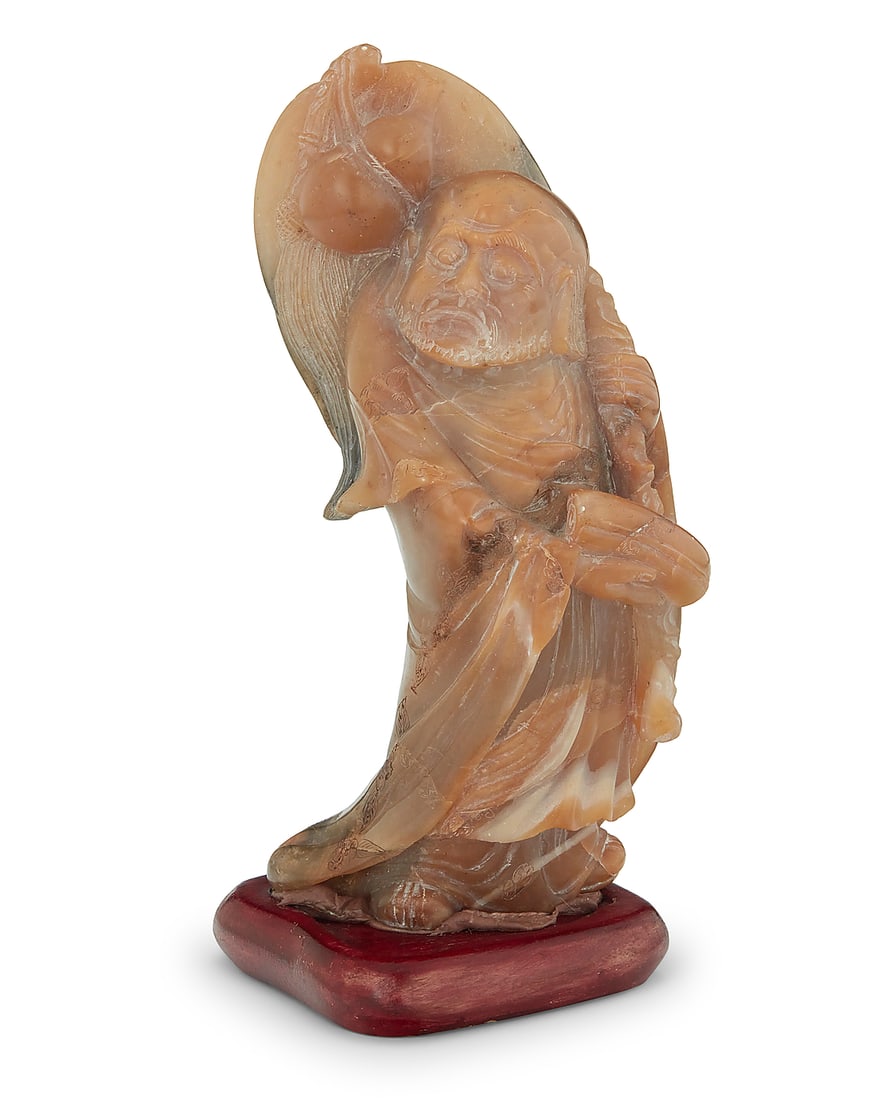 A Chinese carved soapstone figure of a Bodhisattva: A Chinese carved soapstone figure of a Bodhisattva Late Qing Dynasty/Republic Era (1644-1949) or later Possibly shoushan stone, with incised decorations to robe, raised on a carved wood base, housed