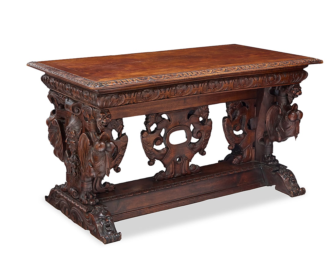 A Renaissance style carved walnut library table: A Renaissance style carved walnut library table 19th century Depicting grotesque beasts and masks 31.5" H x 56" W x 29.5" D