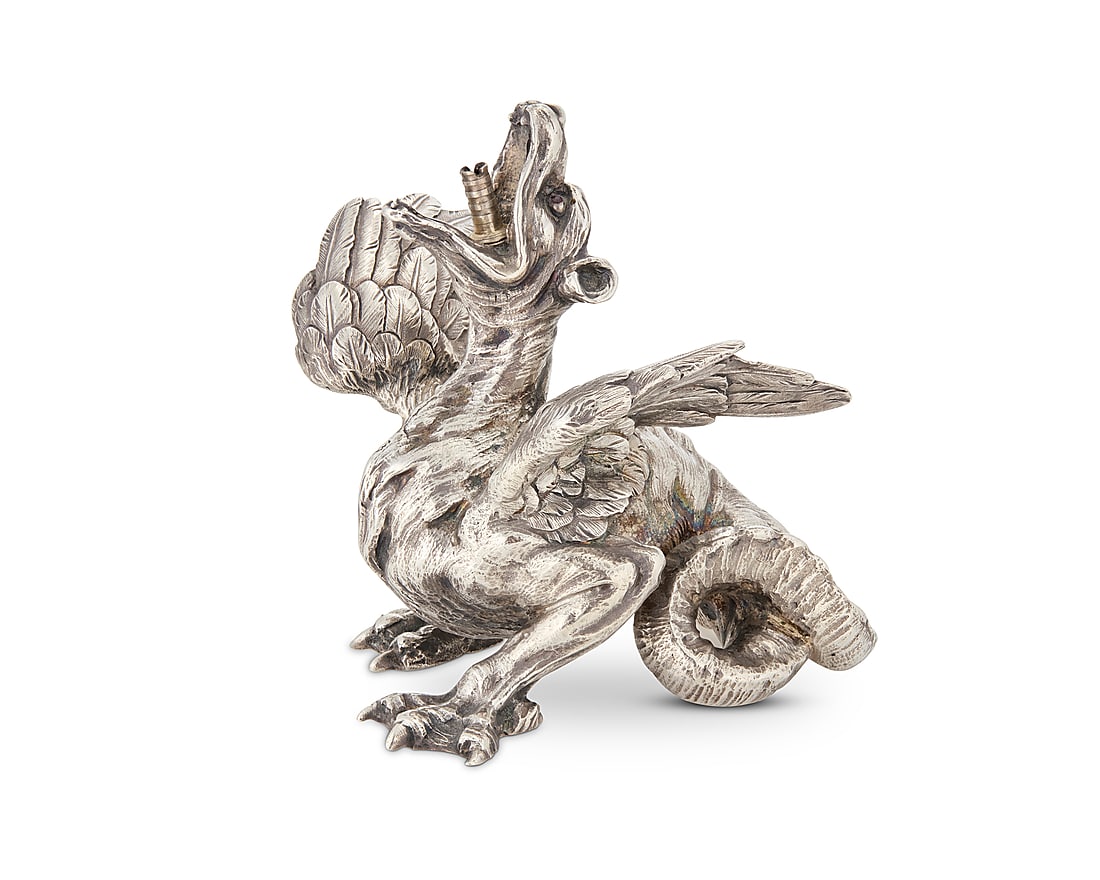 A Faberge ruby set silver dragon table lighter: A Faberge ruby set silver dragon table lighter Circa 1900 Marked for 84 zolotnik and with Cyrillic factory mark With ruby inset eyes, housed in London retailer's original wood and silk-lined presentat