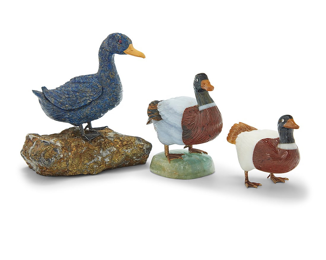 Three carved hardstone models of ducks: Three carved hardstone models of ducks Late 20th century Comprising one lapis lazuli duck mounted on a pyrite base, and two mixed hardstone ducks, one raised on a quartz base, each with metal feet 3