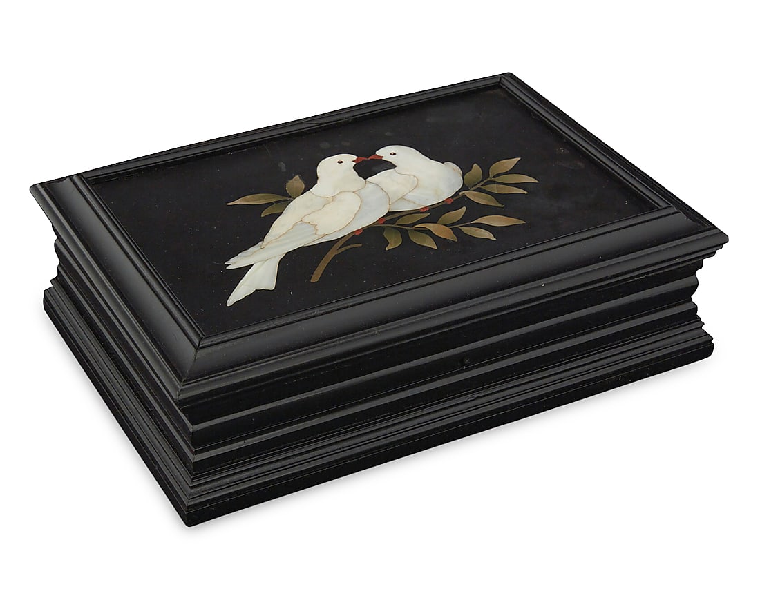 An Italian pietra dura inlaid box: An Italian pietra dura inlaid box Early 20th century Depicting a pair of doves and an olive branch, set into an ebonized wood box with locking hinged lid 2.25" H x 7.625" W x 5.375" D