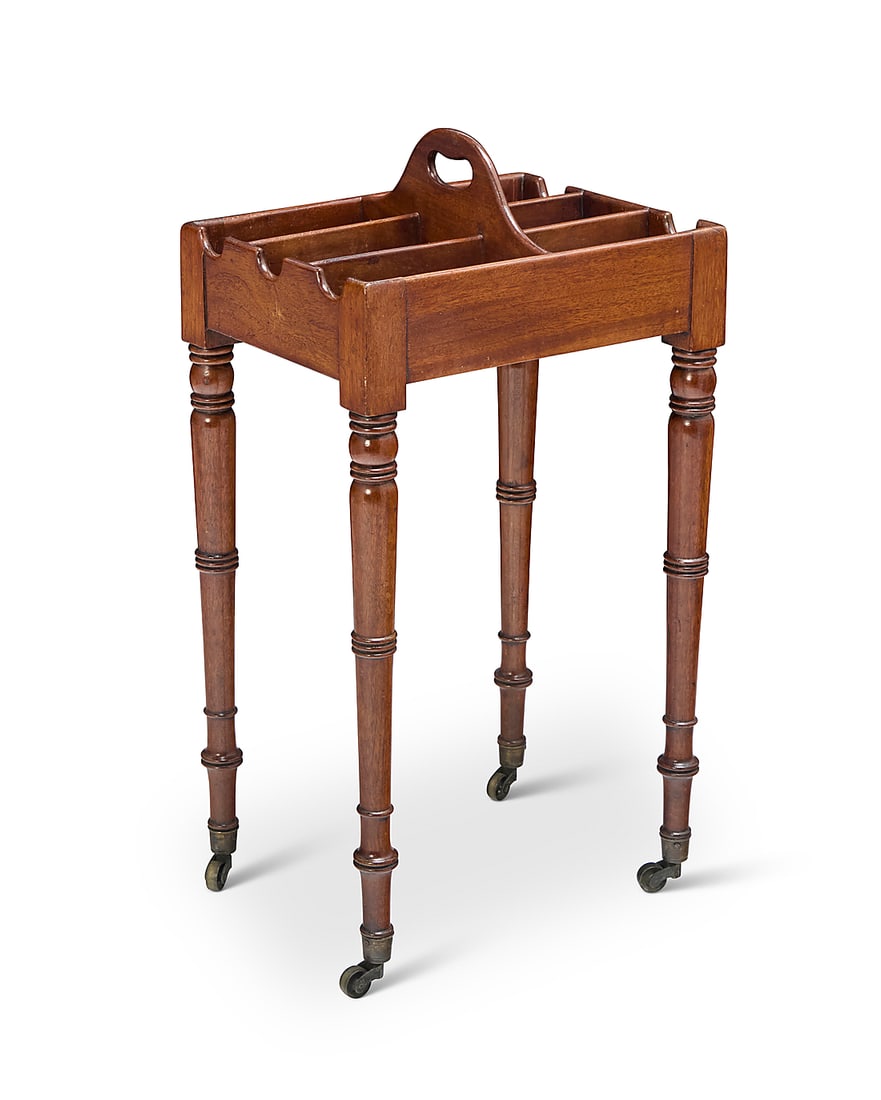 A Louis XVI style rafraichissoir: A Louis XVI style rafraichissoir 19th century With six cubbies for wine and liquor bottles, raised on turned legs with brass casters 33" H x 17.5" W x 13.5" D