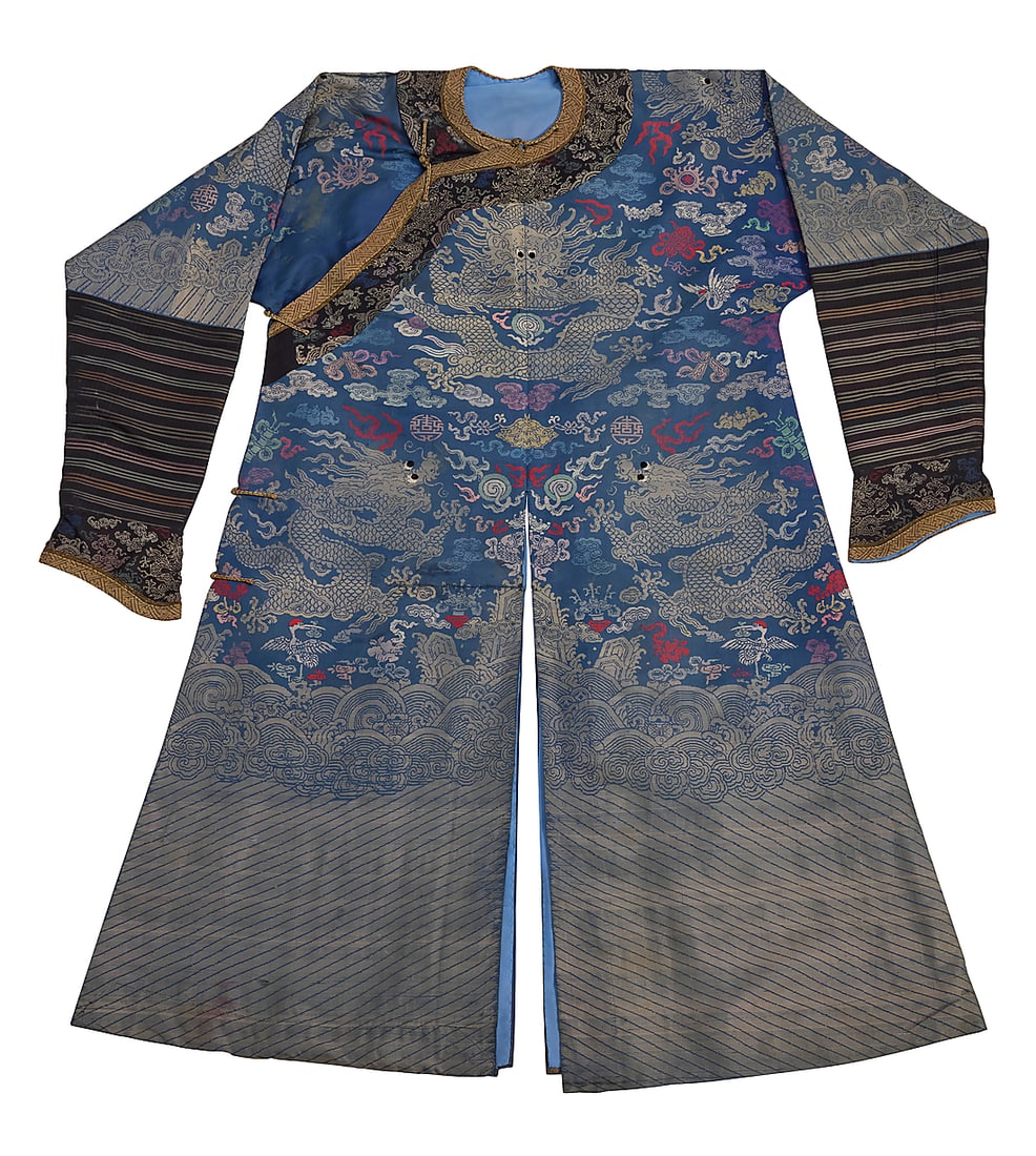 A Chinese blue and gilt thread brocade Dragon robe: A Chinese blue and gilt thread brocade Dragon robe Late Qing dynasty or later The long robe in silk, cotton, and gilt-toned thread, the multicolor brocade depicting seven dragons with embroidered eyes