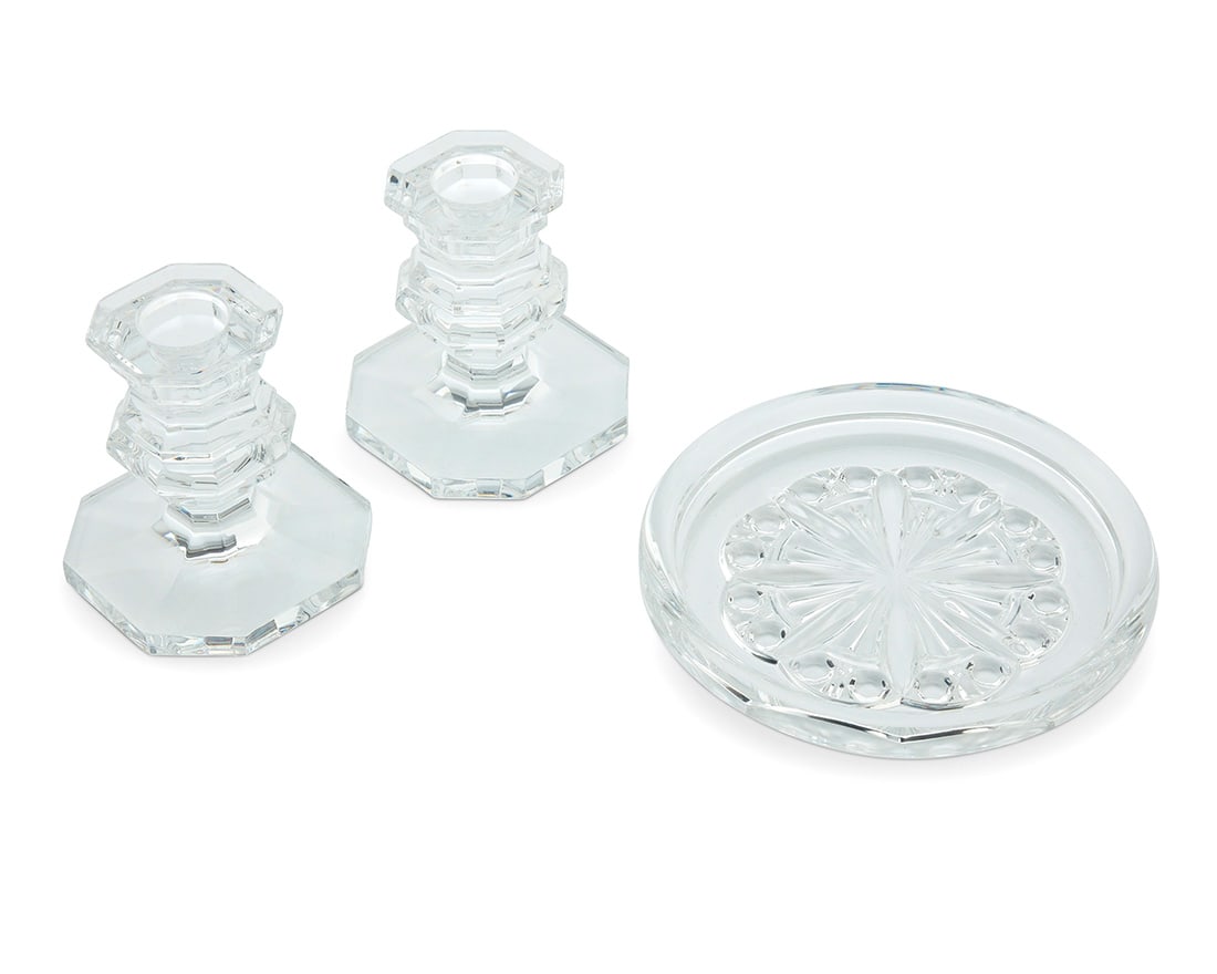 A set of Baccarat glass 'Rosace' coasters and 'Regence' candlesticks: A set of Baccarat glass 'Rosace' coasters and 'Regence' candlesticks Late 20th century Each with etched factory mark Comprising three pairs of 'Regence' candlesticks and three 'Rosace' wine bottle/dec