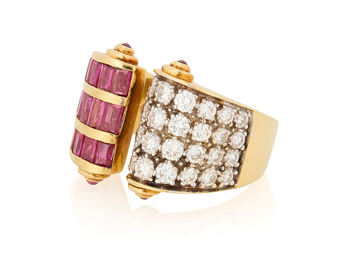 An 18K Gold, Diamond and Ruby Ring: An 18K Gold, Diamond and Ruby Ring Of a scrolling design featuring three rows of rectangular-cut rubies, accented by four rows of graduated round diamonds and finished with four round cabochon