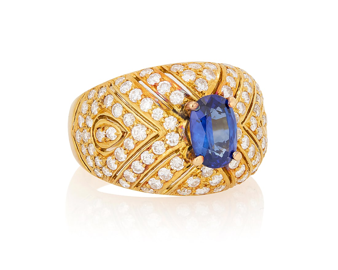 An 18K Gold, Sapphire and Diamond Ring: An 18K Gold, Sapphire and Diamond Ring Centering an oval sapphire weighing approximately 1.47 carats, set in a domed design accented by round diamonds Size: 8 1/2 11.96 grams gross