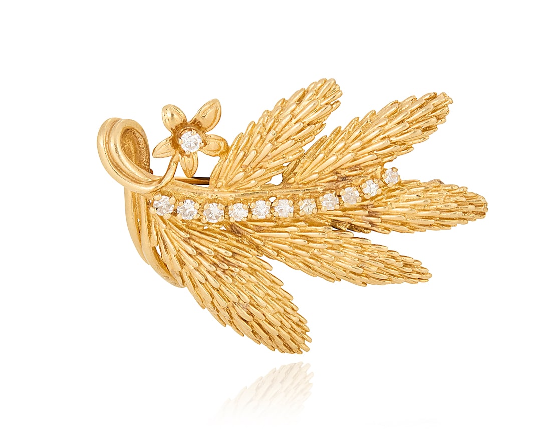 A 14K Gold and Diamond Brooch: A 14K Gold and Diamond Brooch Of a textured foliate design accented by twelve round diamonds weighing approximately 0.36 carat Measures: 1 7/8 x 1 3/8 in. 15.7 grams