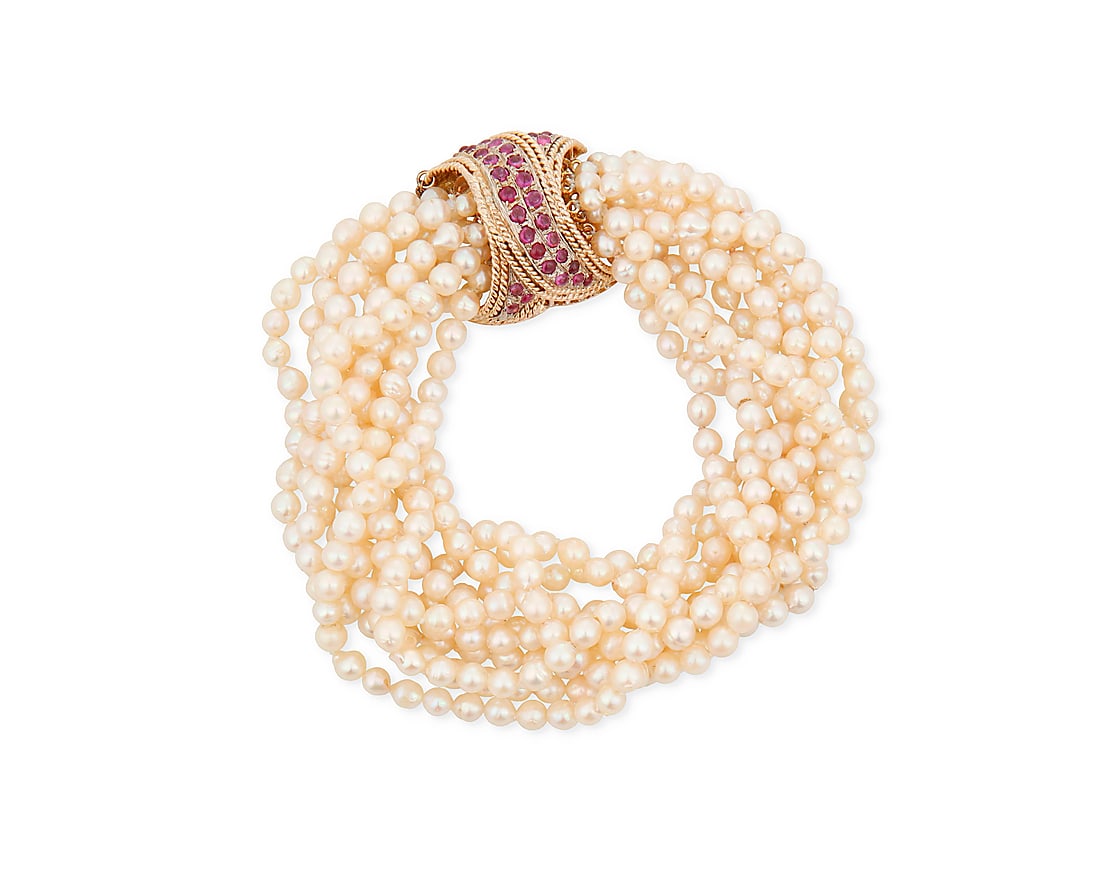 A 14K Gold, Cultured Pearl and Ruby Bracelet: A 14K Gold, Cultured Pearl and Ruby Bracelet Featuring eleven strands of cultured pearl beads measuring approximately 4.9 mm, finished with a gold and ruby cabochon clasp Length: 7 3/4 in. 92.6 grams 