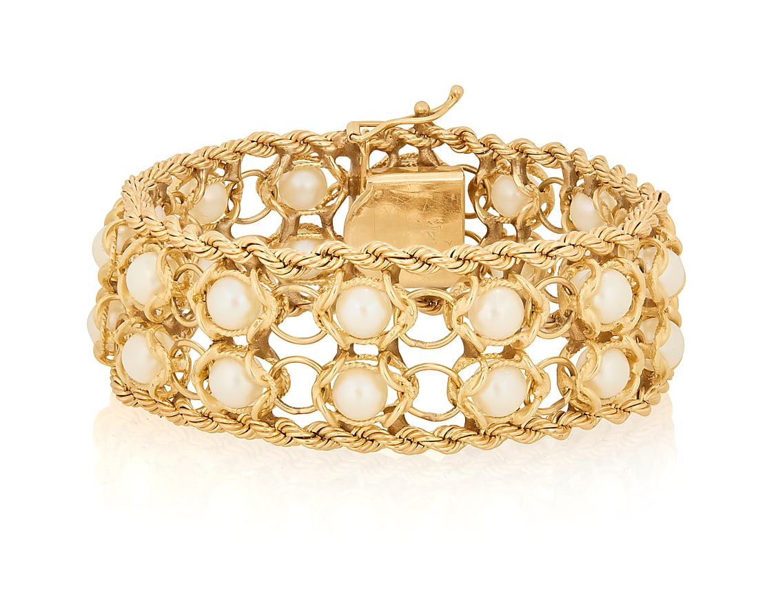 A 14K Gold and Cultured Pearl Bracelet: A 14K Gold and Cultured Pearl Bracelet Featuring two rows of cultured pearls set in fancy interlocking links, finished with two bands of rope gold Length: 7 3/4 in., Width: 1 in. 52.0 grams gross