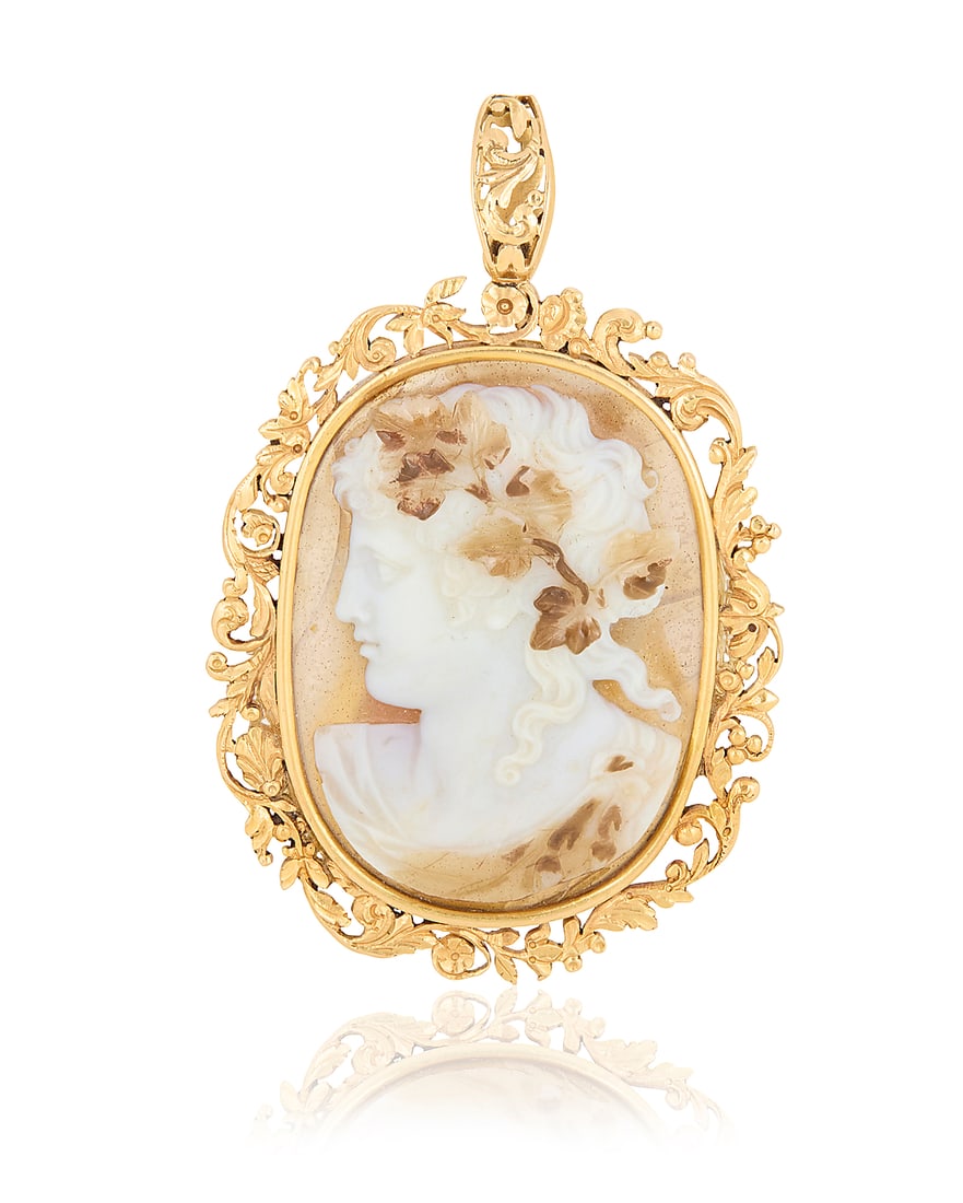 An 18K Gold and Double-Sided Agate Cameo Pendant: An 18K Gold and Double-Sided Agate Cameo Pendant Centering an oval carved agate double cameo featuring a Bacchus motif and female profile set in an ornate floral frame Measures: 2 1/2 x 1 1/2 in.