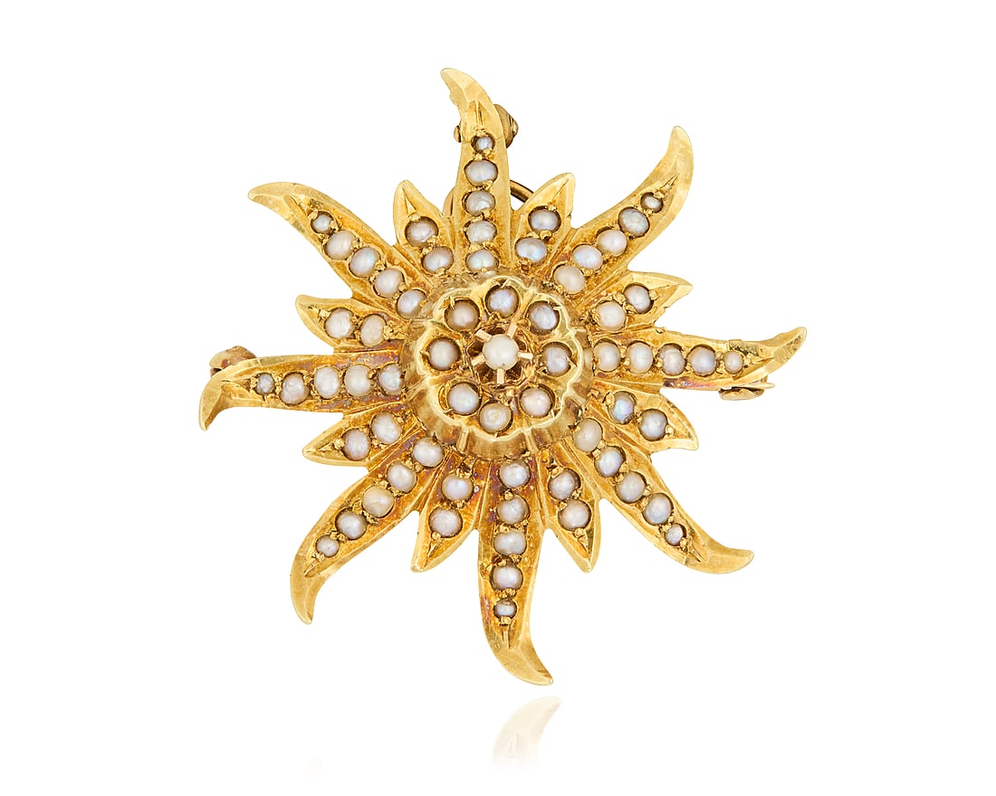 A 14K Gold and Seed Pearl Pendant/Brooch: A 14K Gold and Seed Pearl Pendant/Brooch Of a starburst design set with seed pearls, featuring an extendible bail, with maker's mark E Measures: 1 1/4 x 1 1/4 in. 5.25 grams gross