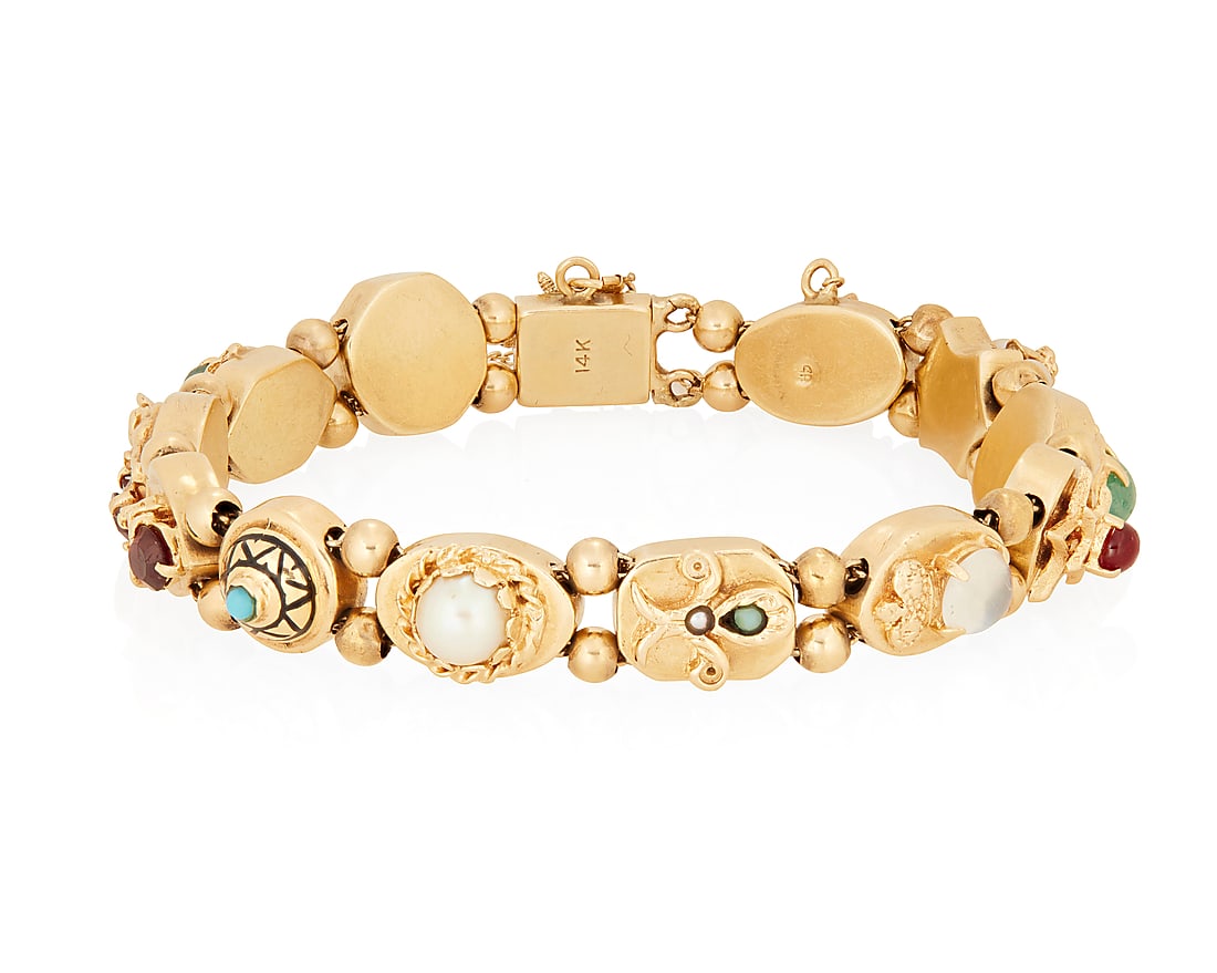 A 14K Gold and Gem-Set Slide Bracelet: A 14K Gold and Gem-Set Slide Bracelet Featuring sliding links of geometric and floral designs set with jade, coral, citrine, garnet and moonstone Length: 7 in. 33.1 grams gross