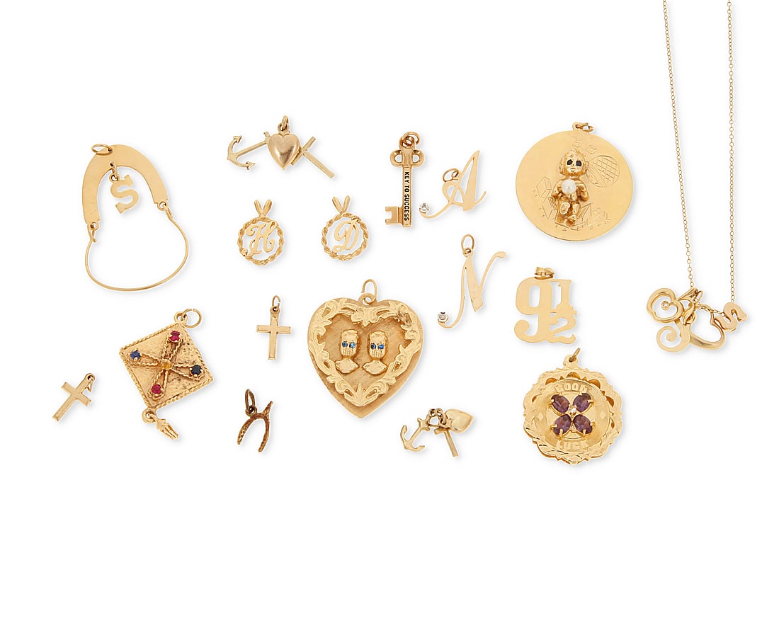 A Group of Gold Charms: A Group of Gold Charms Including a charm necklace, charm holder, crosses, initials and key to success 17 pieces Measures: 1/2 - 2 in. 56.0 grams gross