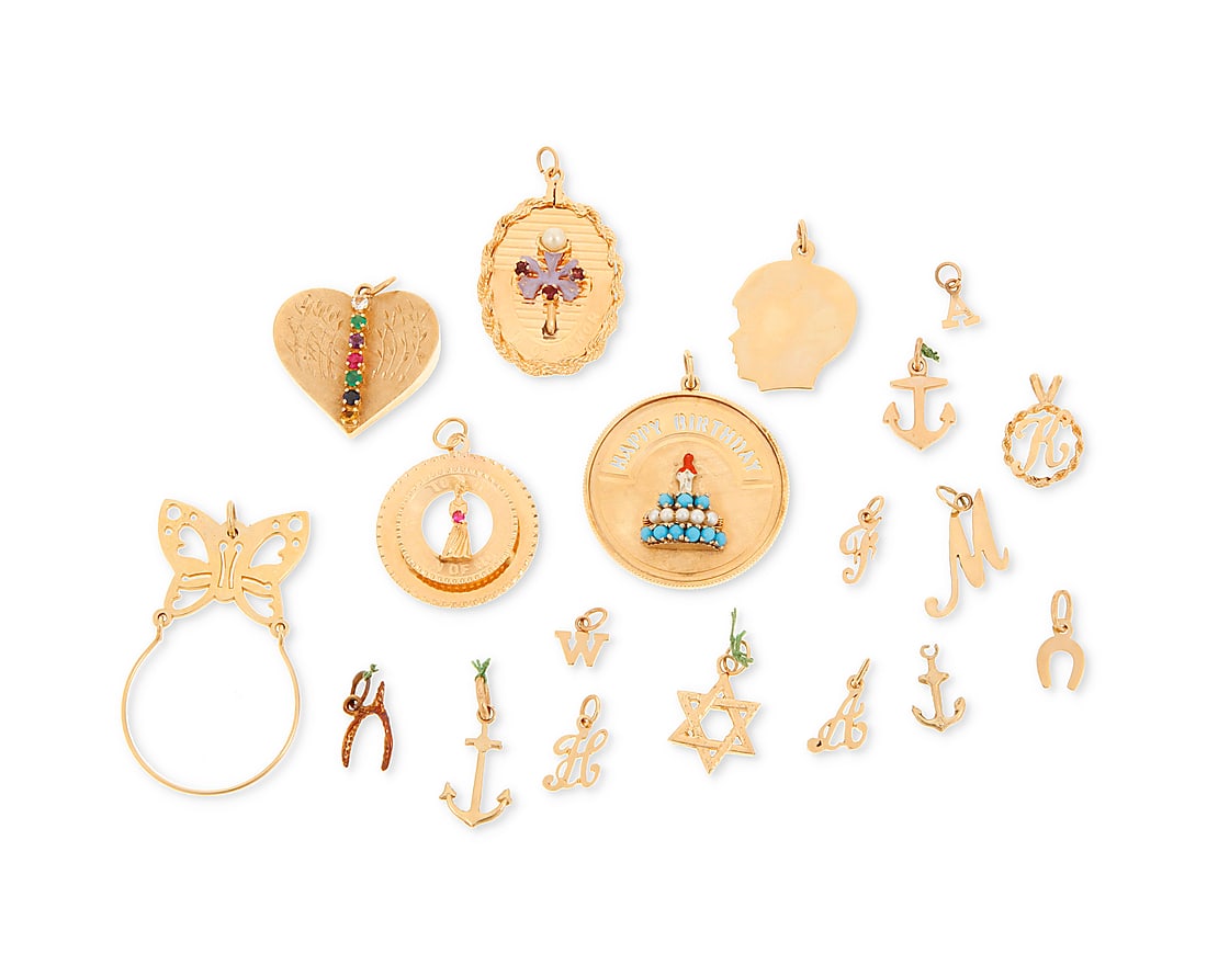A Group of Gold Charms: A Group of Gold Charms Including a butterfly charm holder, initials, anchors and happy birthday charm 19 pieces Measures: 3/8 - 2 in. 41.0 grams gross