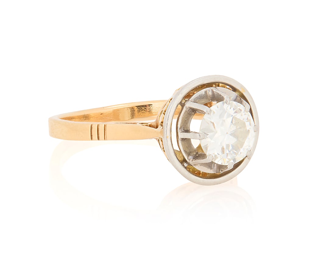 An 18K Gold, Platinum and Diamond Ring: An 18K Gold, Platinum and Diamond Ring Centering an old European-cut diamond weighing 1.00 carat Size: 7 1/2 4.4 grams gross
