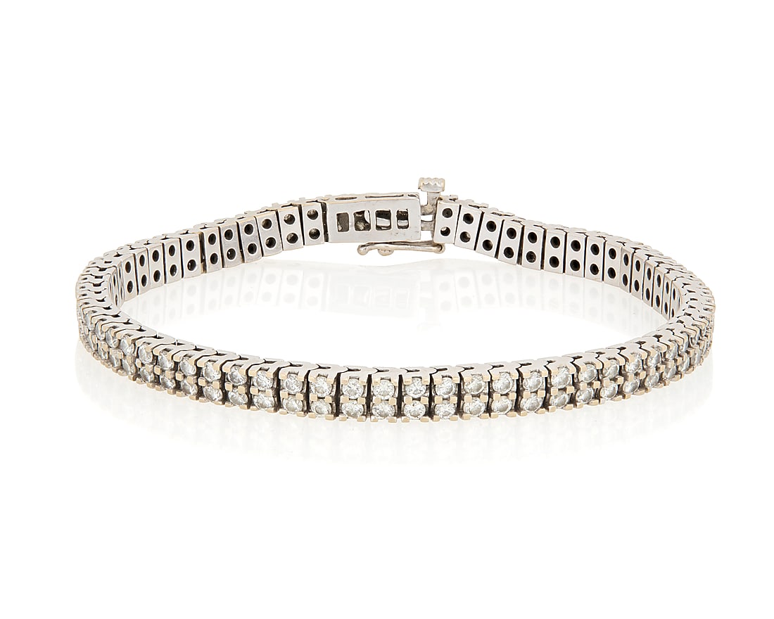 An 18K White Gold and Diamond Bracelet: An 18K White Gold and Diamond Bracelet Featuring two rows of round diamonds weighing approximately 4.00 carats Length: 8 in. 28.8 grams gross