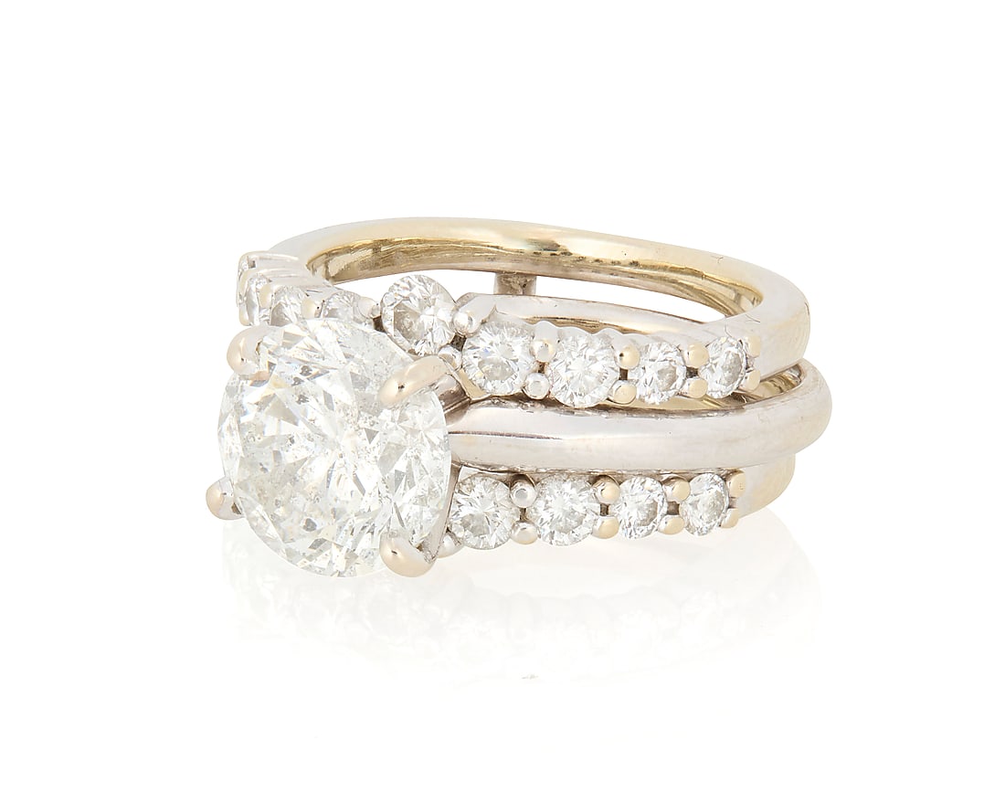 A 14K White Gold Diamond Ring Wedding Set: A 14K White Gold Diamond Ring Wedding Set Centering around diamond weighing approximately 2.48 carats, together with a jacket featuring two bands of round set diamonds in a chevron design 2 pieces