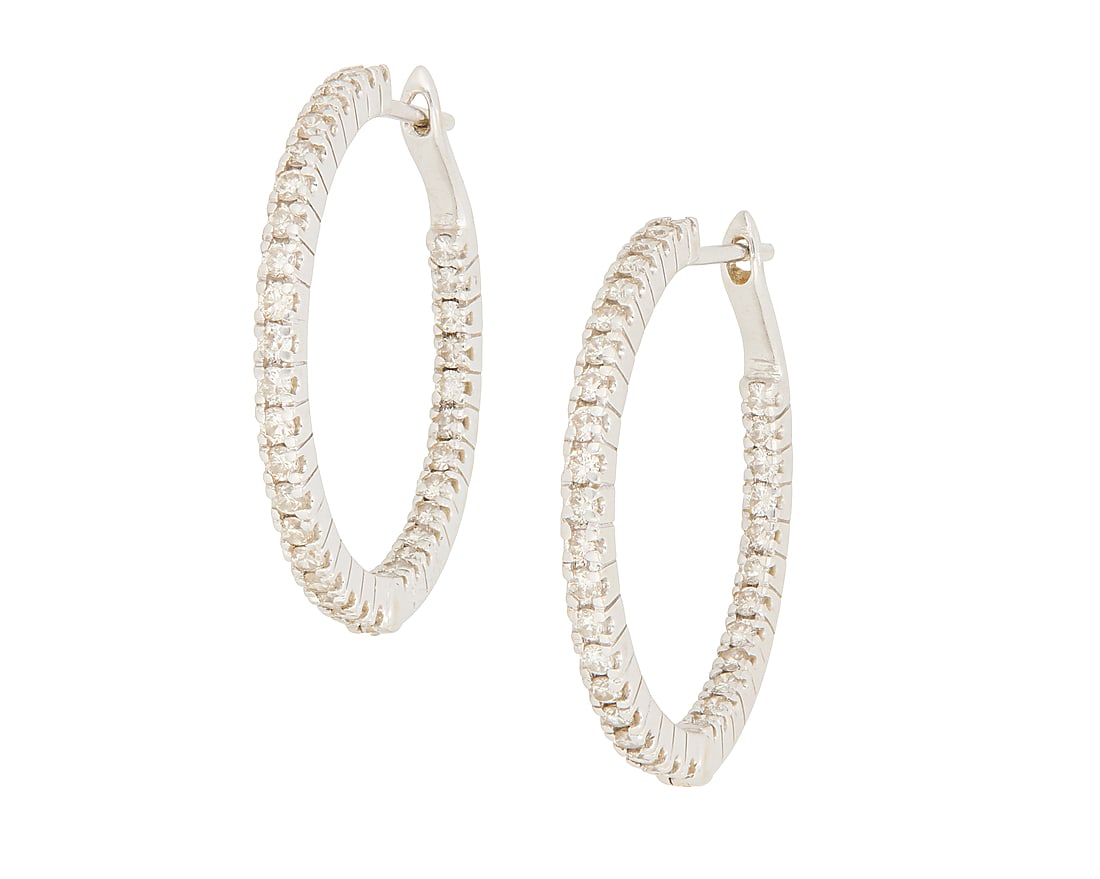 A Pair of 18K Gold and Diamond Hoops: A Pair of 18K Gold and Diamond Hoops Featuring round diamonds set half inside and half outside of the hoop weighing approximately 1.12 carats total 2 pieces Measures: 1 1/8 in. 6.7 grams gross