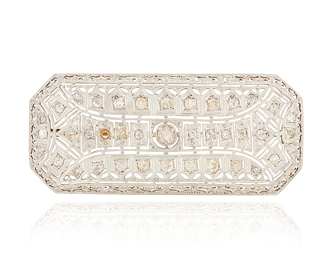 A Platinum Topped-Gold and Diamond Brooch: A Platinum Topped-Gold and Diamond Brooch Of a geometric openwork design featuring old mine-cut diamonds weighing approximately 3.00 carats Measures: 2 1/2 x 1 1/8 in. 15.1 grams gross This lot is
