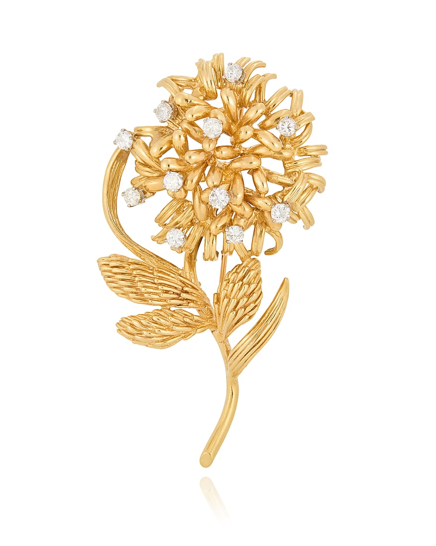 A 14K Gold and Diamond Brooch: A 14K Gold and Diamond Brooch Of a flower design accented by eleven round diamonds weighing approximately 1.10 carats Measures: 2 1/2 x 1 3/8 in. 21.4 grams gross
