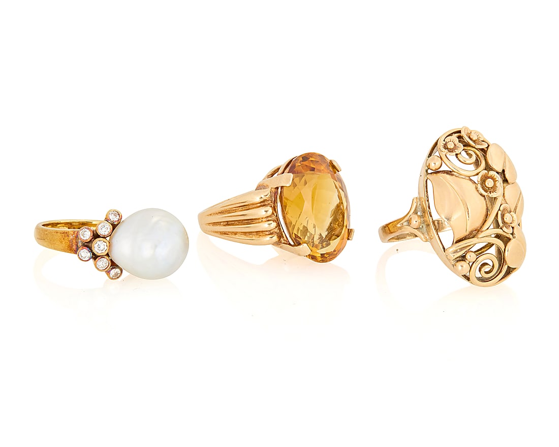 A Group of Three 14K Gold Rings: A Group of Three 14K Gold Rings Featuring a baroque cultured pearl, an oval citrine and one of a scrolling floral design 3 pieces Sizes: 6, 7 3/4 and 8 1/2 31.3 grams gross This lot is being offered w