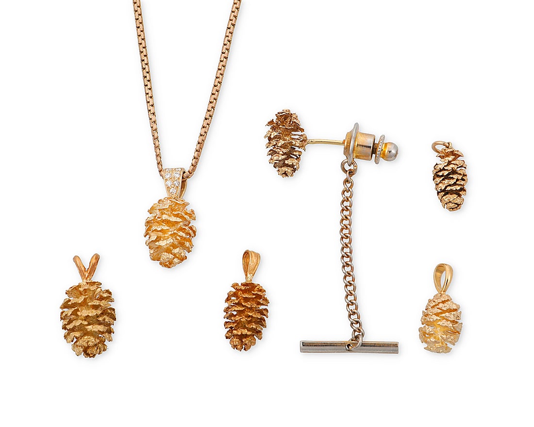 A Group of Gold Jewelry: A Group of Gold Jewelry Including four 14k gold pendants, one pin and one pendant necklace including a 9k gold chain all of a pinecone design 6 pieces Chain: 18 in., Pendants: 3/4 - 7/8 in. 22.9