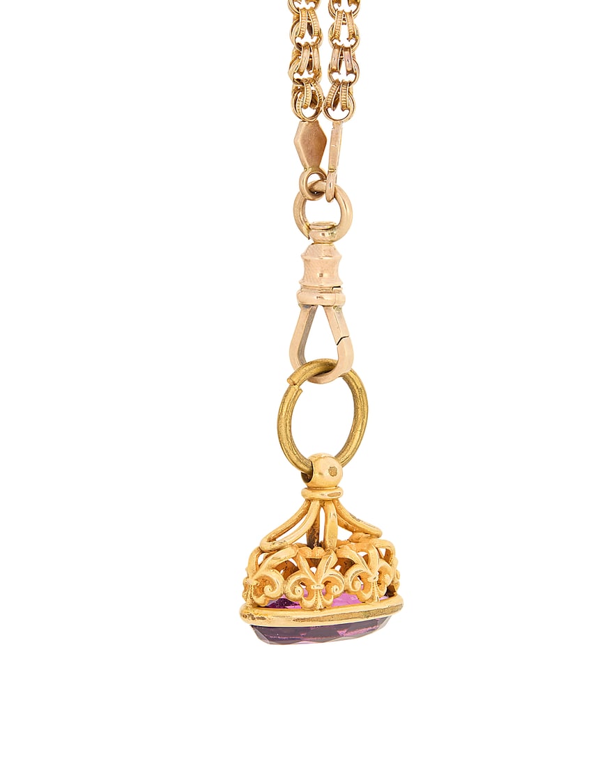 A Gold Chain and Amethyst Fob: A Gold Chain and Amethyst Fob Featuring a 10k gold long fancy link chain, suspending a brass jump ring with a 14k gold and amethyst fob Chain: 64 in., Fob: 7/8 x 7/8 in. 44.2 grams gross This lot is