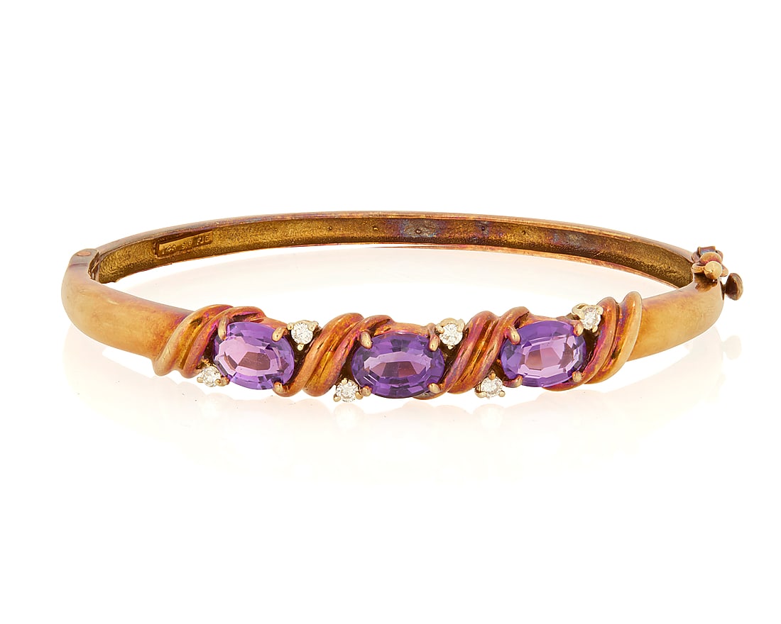 A 14K Gold, Amethyst and Diamond Bracelet: A 14K Gold, Amethyst and Diamond Bracelet Of a hinged design centering three oval amethyst accented by six round diamonds, signed FJG Inner circumference: 6 1/2 in. 16.3 grams gross This lot is being