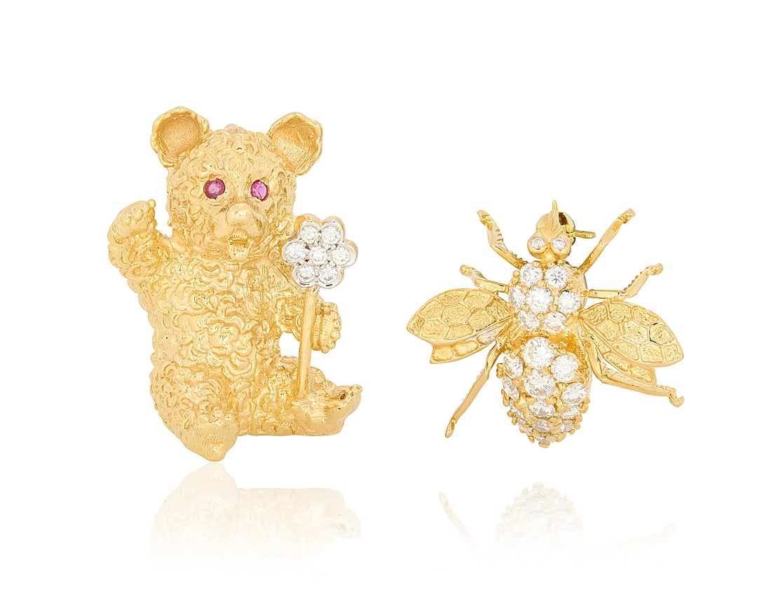 Two 18K Gold Animal Brooches: Two 18K Gold Animal Brooches Including a bear holding a flower set with round diamonds and two rubies, together with a bee accented by round diamonds weighing approximately 0.75 carats 2 pieces