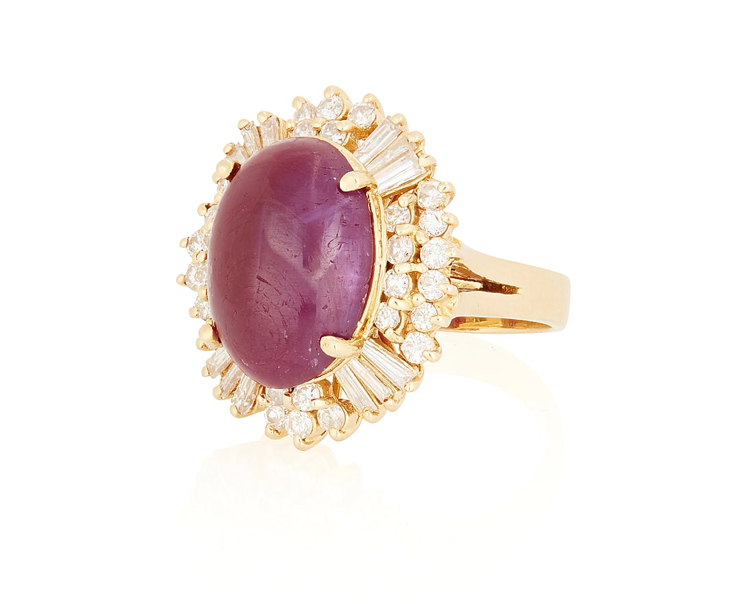 A 14K Gold, Ruby and Diamond Ring: A 14K Gold, Ruby and Diamond Ring Centering an oval ruby cabochon measuring approximately 116.33 x 11.82 x 5.58 mm, accented by round and tapered baguette diamonds weighing approximately 1.50 carats