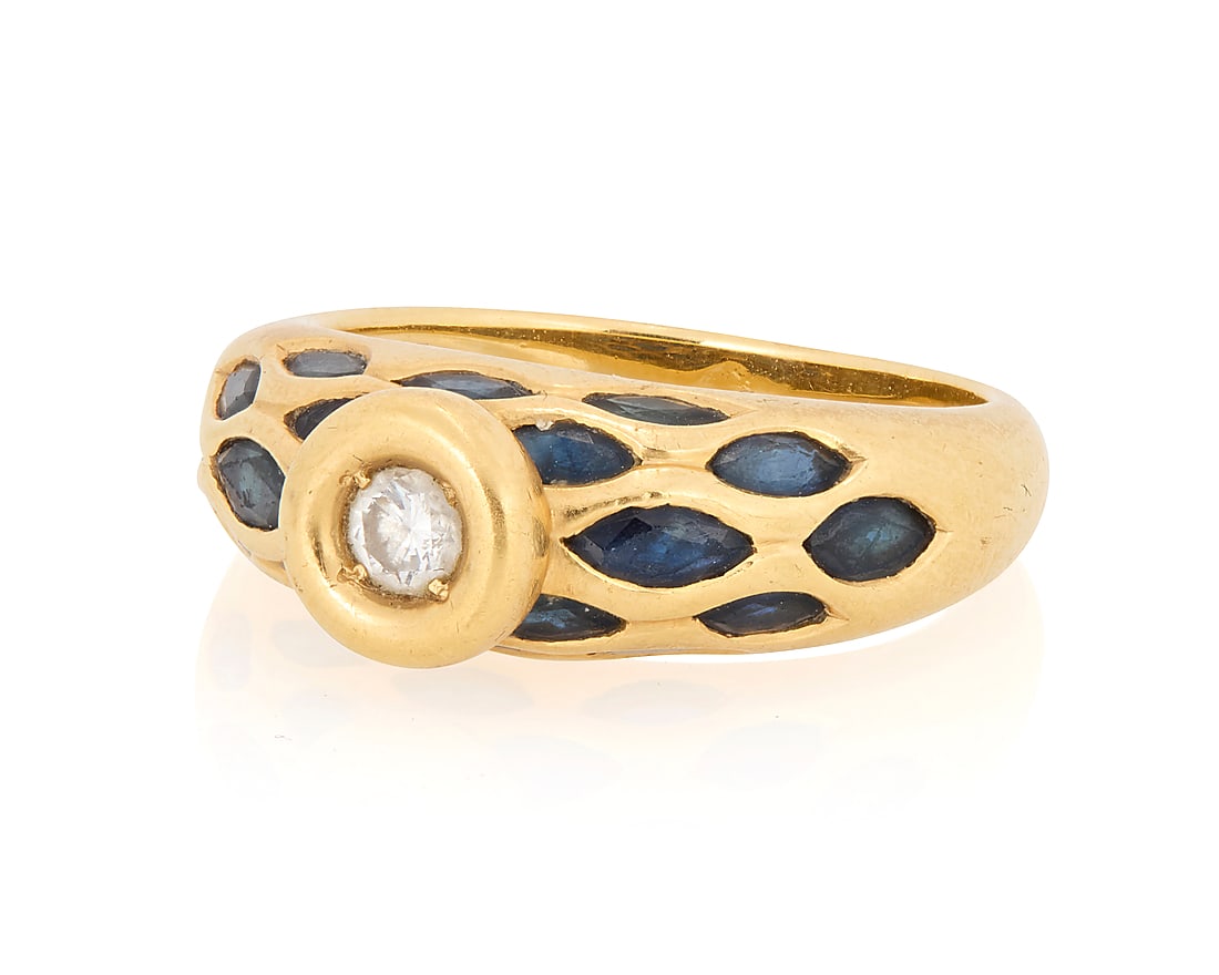 An 18K Gold, Sapphire and Diamond Ring: An 18K Gold, Sapphire and Diamond Ring Featuring marquise-shaped sapphires centering a single round diamond Size: 6 1/2 5.7 grams