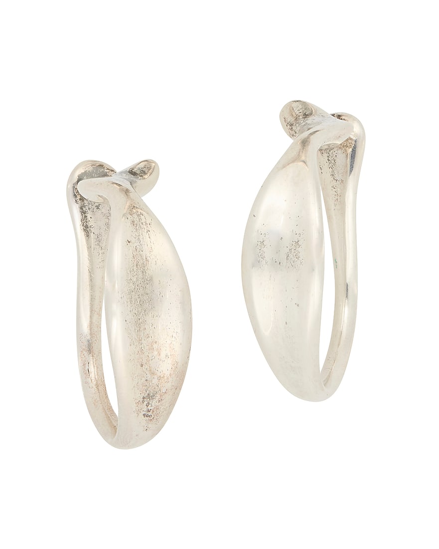 Elsa Peretti for Tiffany & Co.: A Pair of Sterling Silver Hoops: Elsa Peretti for Tiffany & Co.: A Pair of Sterling Silver Hoops The large sculptural abstract ear cuff hoops with tapered and shaped ends, each marked for artist and for sterling 2 pieces Each: 1 1/2 