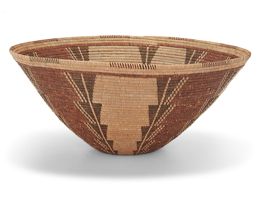 A large Panamint Shoshone polychrome basketry bowl: A large Panamint Shoshone polychrome basketry bowl Early 20th century; Great Basin The coiled bowl with partial rim ticking above four stepped columns 7.75" H x 17.5" Dia. Provenance: Palm Springs Mus