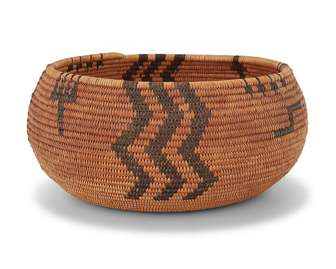 A Paiute basketry bowl: A Paiute basketry bowl Early 20th century; Great Basin The coiled bowl with alternating triple zig-zags and triple stacked arrows, with other floating elements 3.125" H x 6.875" Dia. Provenance: The