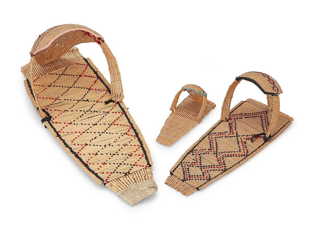 Three Paiute basketry cradleboards: Three Paiute basketry cradleboards Mid/late 20th century; Great Basin In graduated sizes, each woven with yarn in geometric designs 3 pieces Largest: 30" L x 10.5" W x 8.625" D; Smallest: 9.875" L x