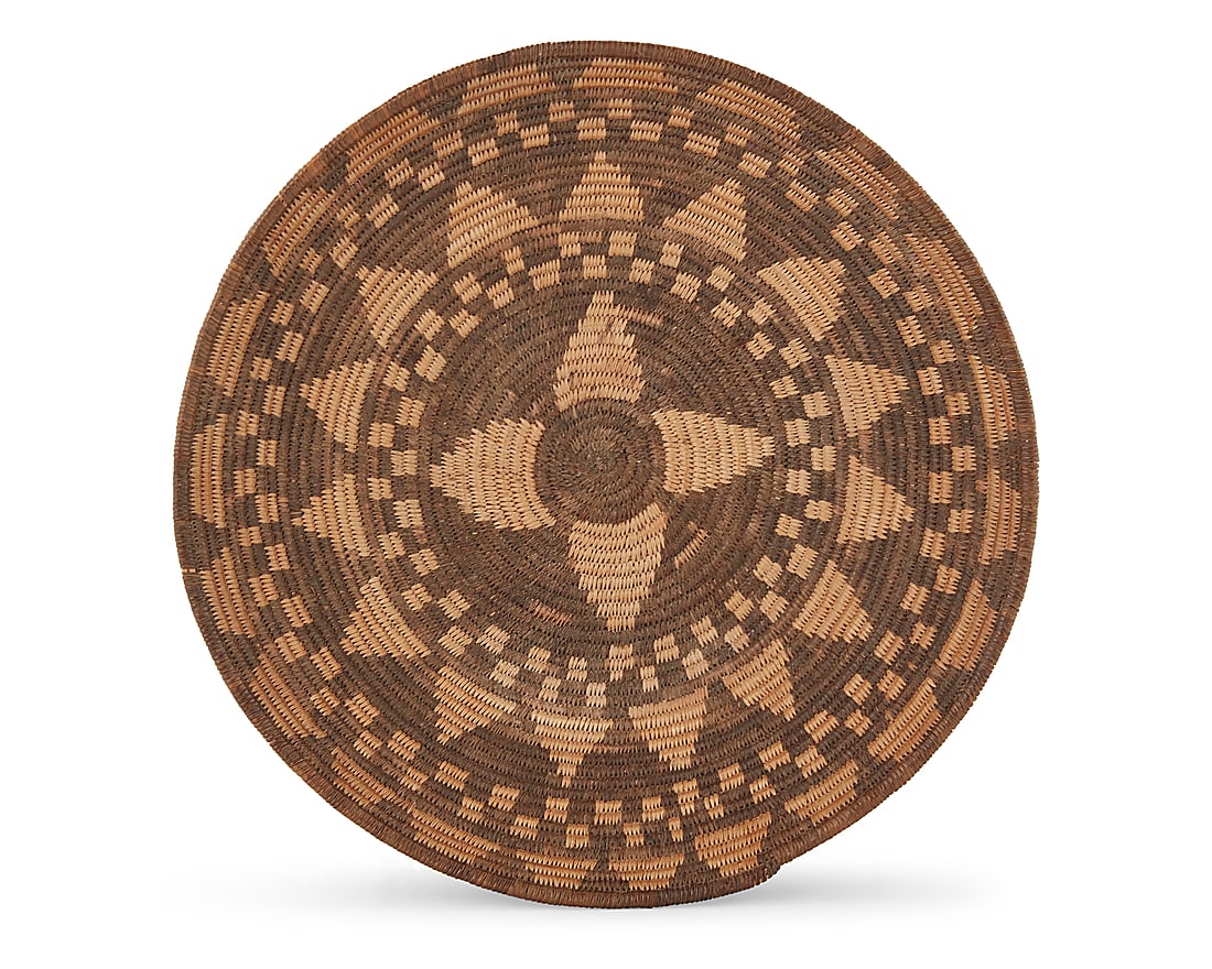 A Yavapai basketry bowl: A Yavapai basketry bowl Early 20th century; Southwest United States The coiled bowl with alternating bands of diamonds and checkers 2.75" H x 12.75" Dia. Provenance: The Robert Stuart Schaefer