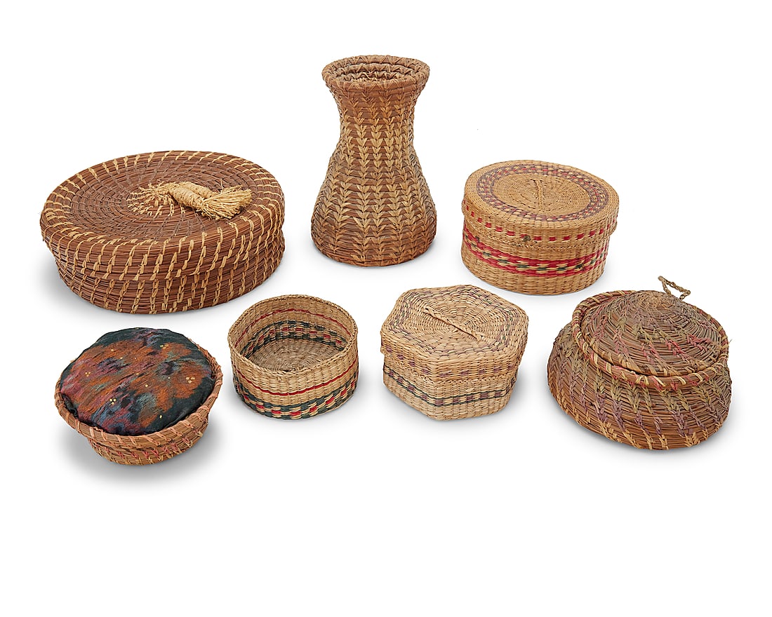 A group of seven Native American baskets: A group of seven Native American baskets Early/mid-20th century Comprising pine needle and sweetgrass: a vase, bowl, lidded basket, and pincushion; and three Northwest Coast polychrome twined