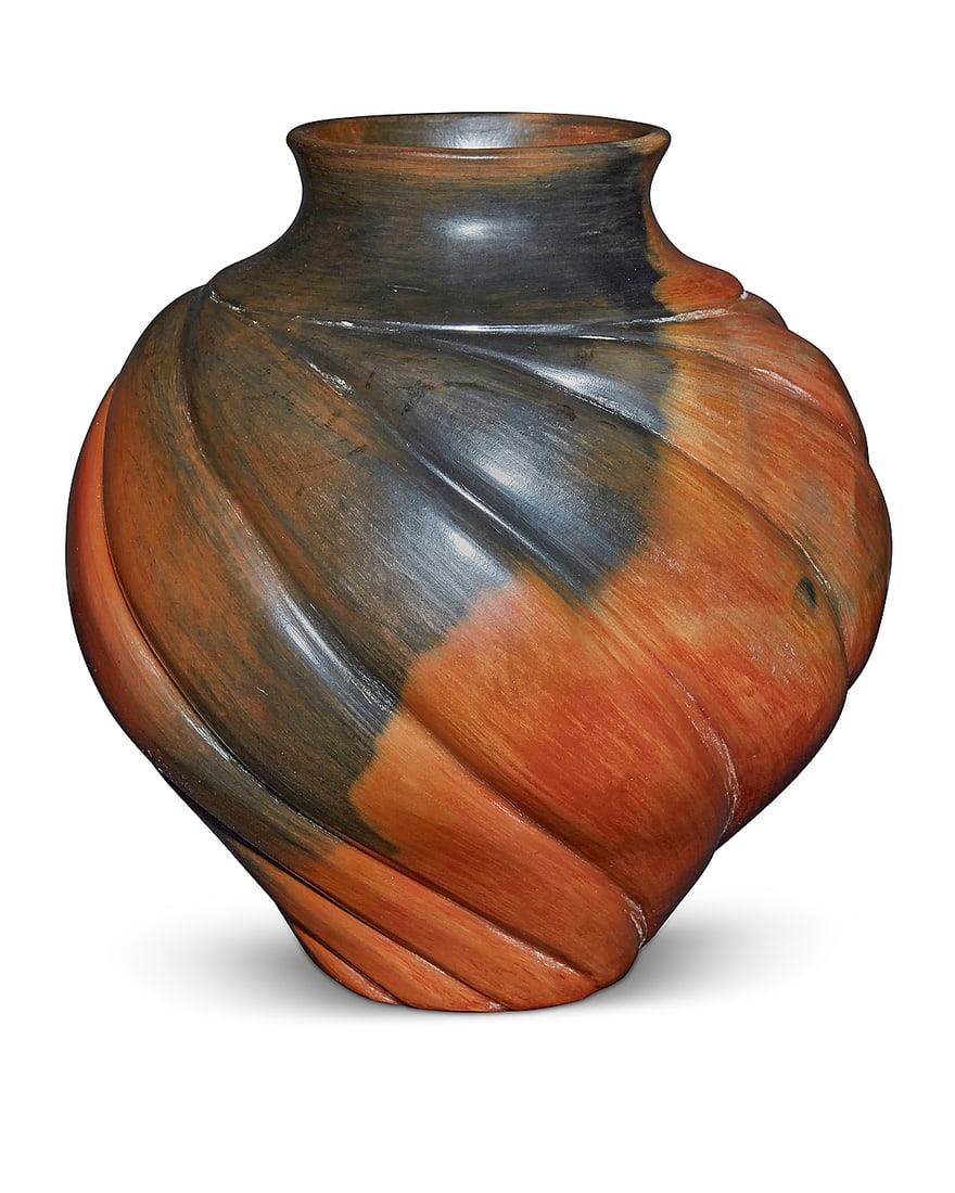 Samuel Manymules (b. 1963, Navajo/Dine), A redware pottery jar, 1990s: Samuel Manymules (b. 1963, Navajo/Dine) A redware pottery jar, 1990s Incised to underside: SM / DINe The melon swirl vase with fire clouding throughout 8.5" H x 7.75" Dia. Provenance: Acquired from Ma