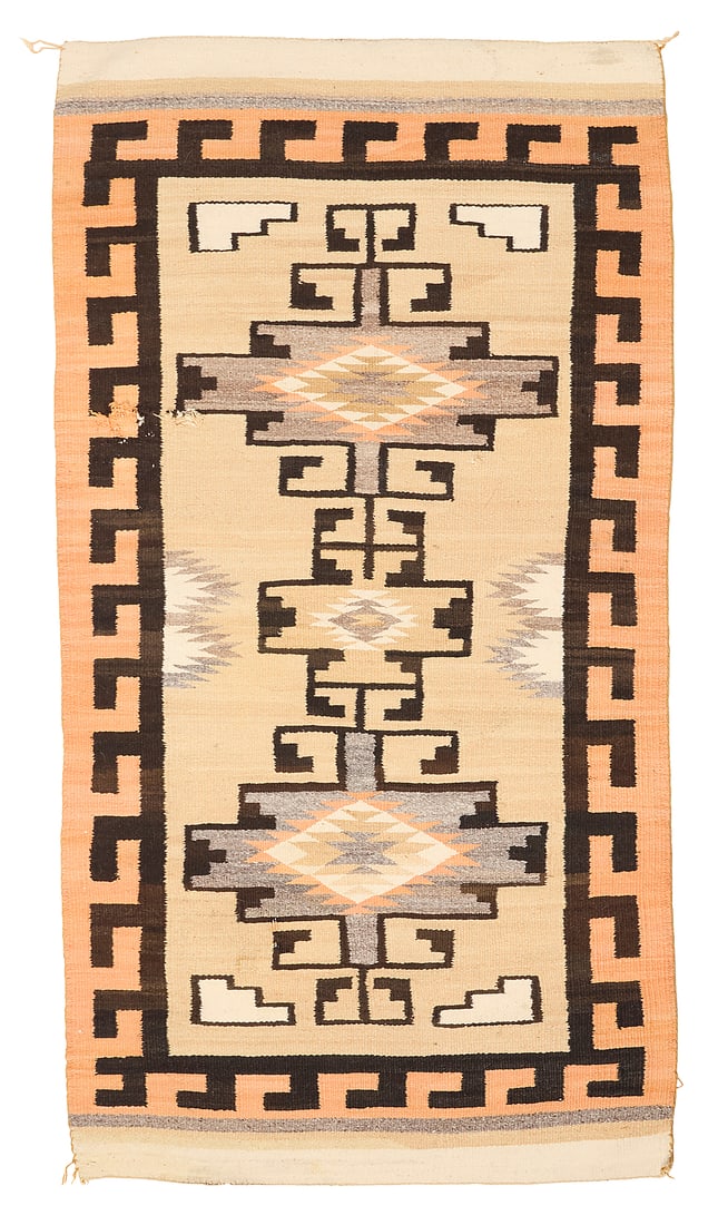 A Navajo regional rug: A Navajo regional rug Mid-20th century, Dine Woven in orange, cream, ochre, tan, cream, dark brown, and natural grey wool, with stacked stepped and hooked diamonds within a hooked border 65.5" H x
