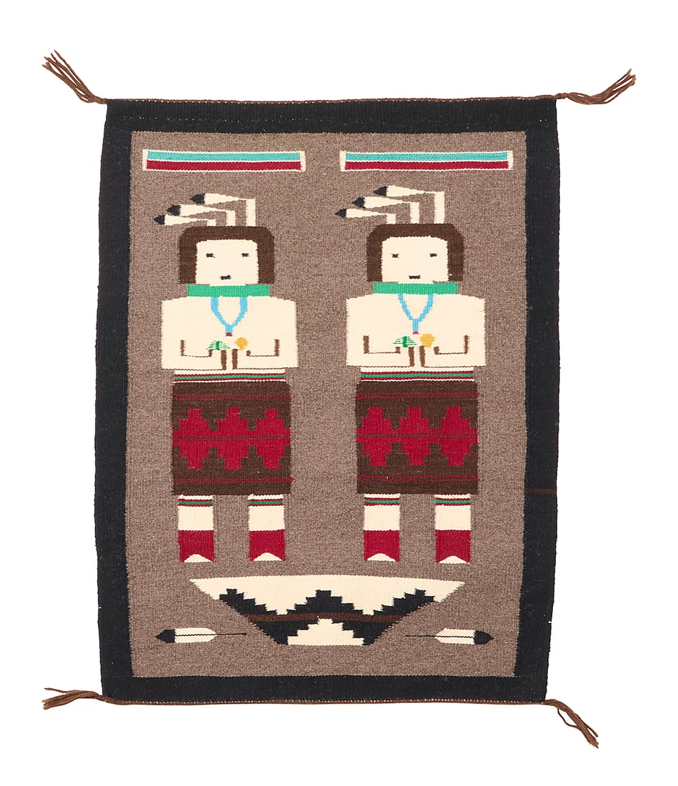 A Navajo pictorial Yei textile: A Navajo pictorial Yei textile Mid/late 20th century, Dine Woven in multicolor wool, depicting two Yei figures with rainbows above and a basket and two feathers below 32.25" H x 24.75" W