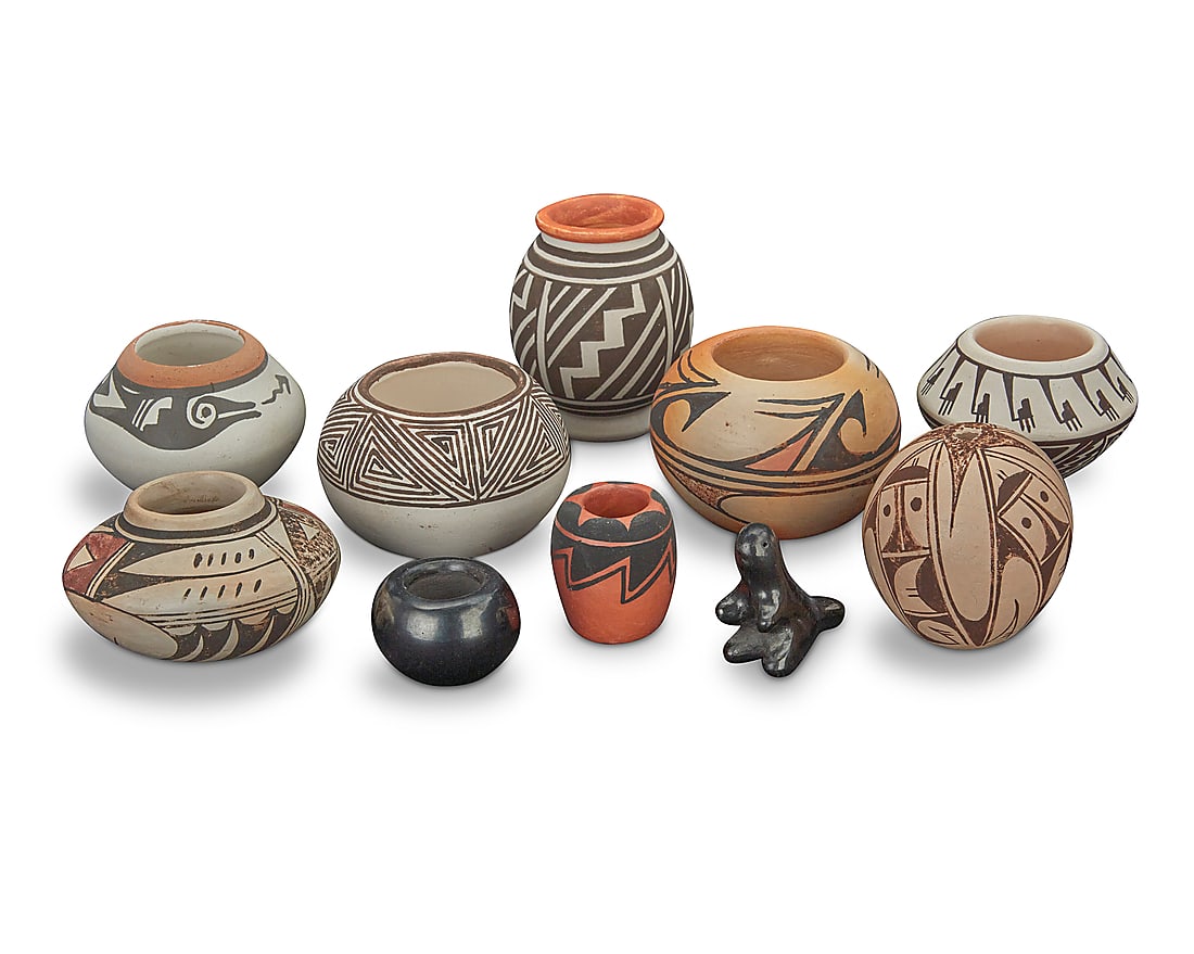 A group of ten diminutive Southwest Pueblo pottery items: A group of ten diminutive Southwest Pueblo pottery items Mid-20th century-early 21st century Each but two variously signed Comprising a Helen [Feather Woman] Naha (1922-1993, Hopi-Tewa) olla, an Emma 