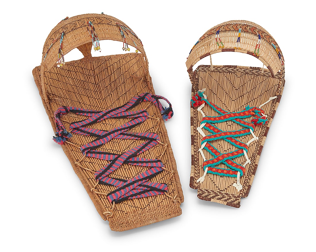 Two Mono basketry cradleboards: Two Mono basketry cradleboards Mid/late 20th century; Central California Comprising a large twined cradleboard with striped and diagonal banding, with integral curved shaped hood adorned with five