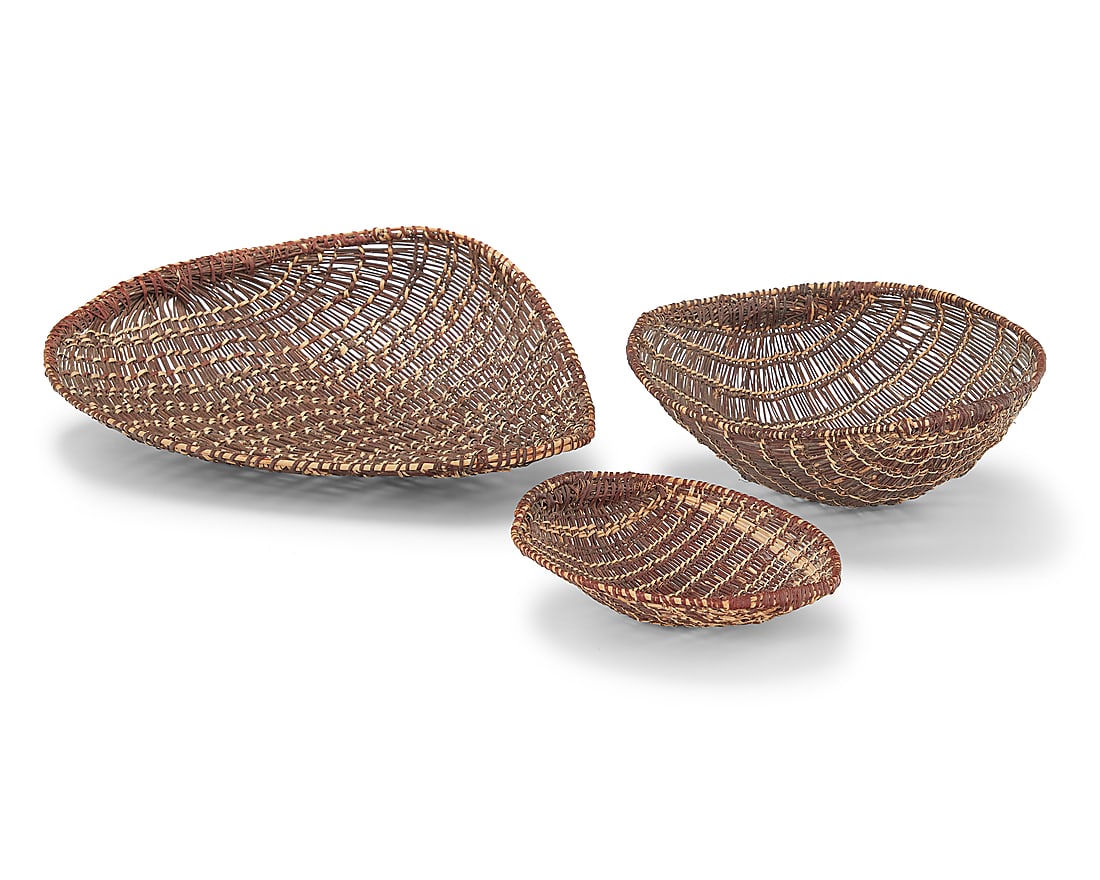 Three Mono winnowing basketry trays: Three Mono winnowing basketry trays Early/mid-20th century In graduated sizes 3 pieces Largest: 5.75" H x 18" W x 15.25" D; Smallest: 2.875" H x 8.375" W x 7.5" D