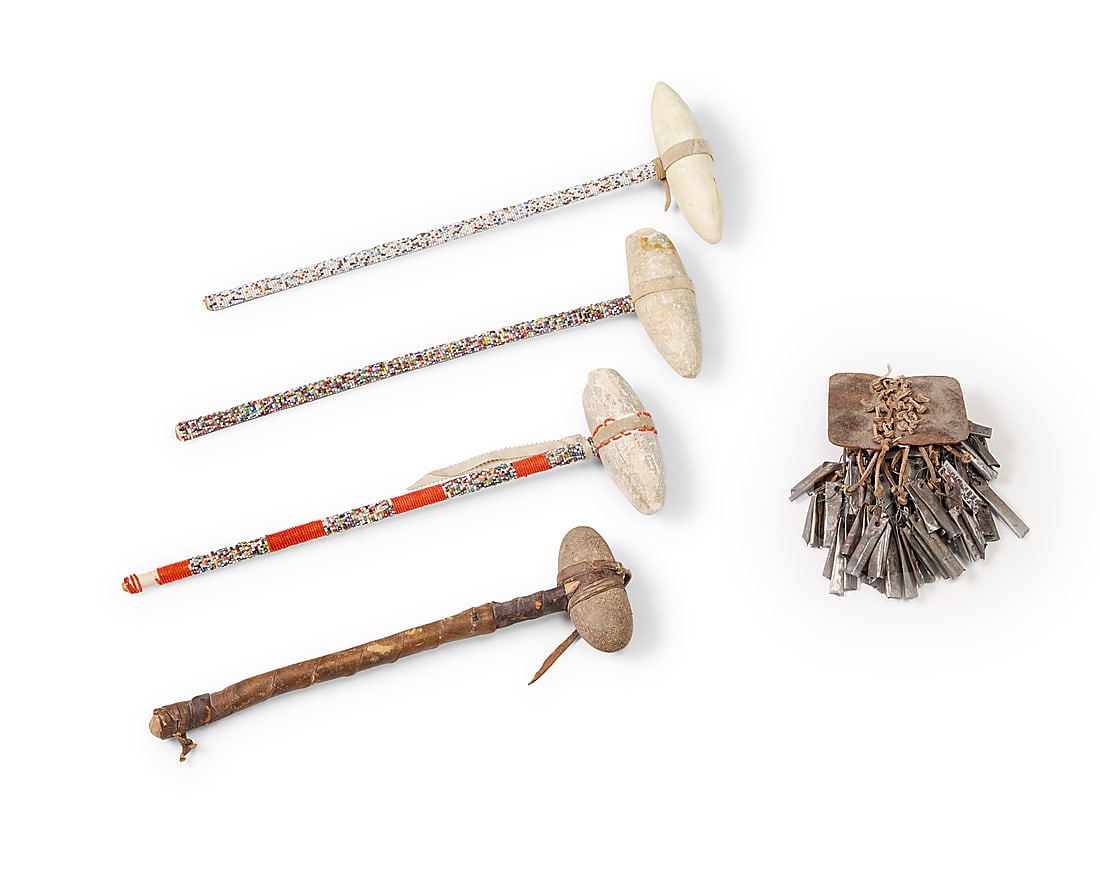 Four Plains style skull crackers: Four Plains style skull crackers 20th century Comprising three beaded shaft clubs and one hide-wrapped club, together with a rattle of cut tin cones 5 pieces Longest: 9.25" H x 6.625" W x 2.875" D; Ti