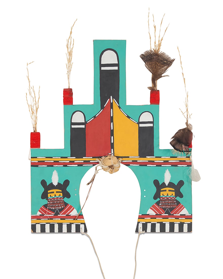 A Hopi polychrome wood dance tableta: A Hopi polychrome wood dance tableta Late 20th/early 21st century Decorated with maiden katsinas and crested by kiva steps mounted with feathers, wild grass, and a circular bundle of grasses, with