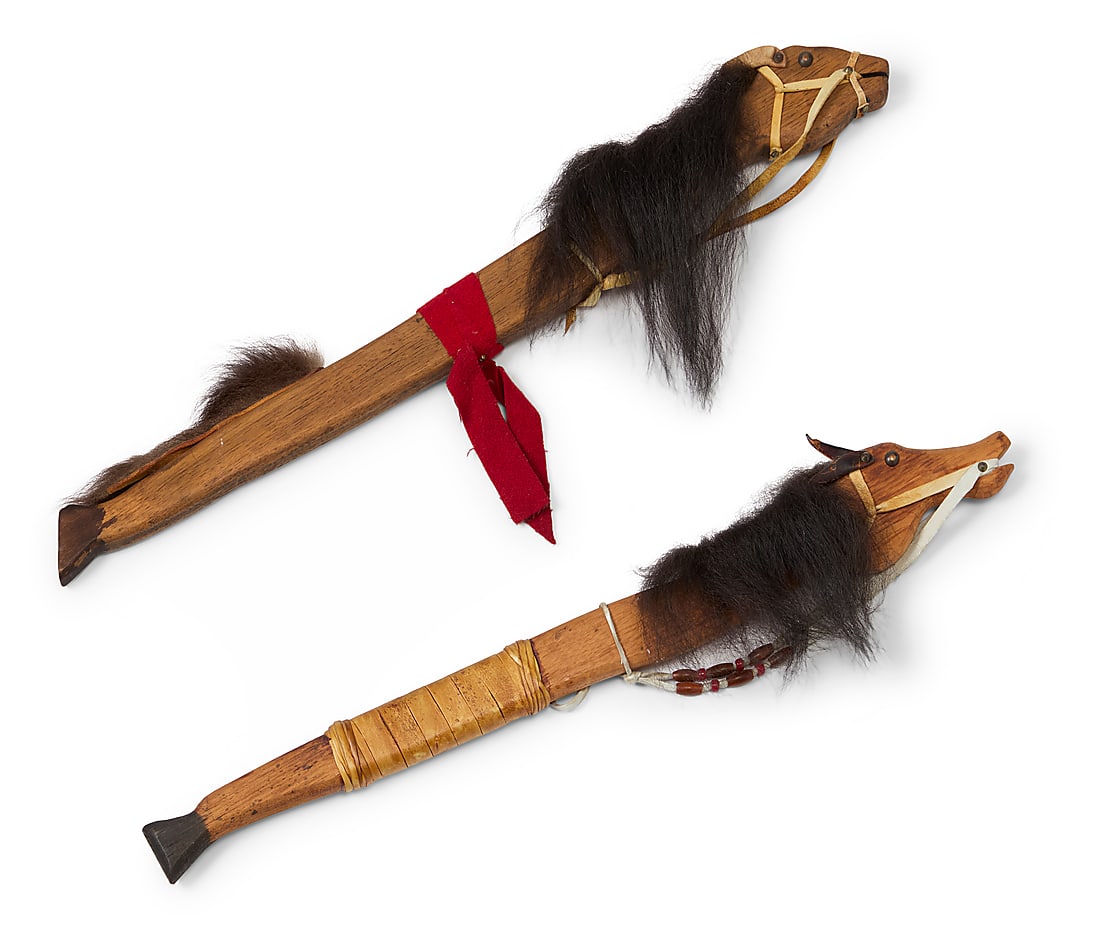 Machinque Peshewa (20th Century, Shawnee), Two horsehead dance wands, mid-20th century: Machinque Peshewa (20th Century, Shawnee) Two horsehead dance wands, mid-20th century Each signed and inscribed: MACHINQUE / PESHEWA / SHAWNEE / [indecipherable] Fur, hide, and brass tacks on carved