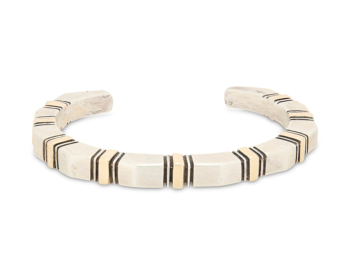 A Nusie Henry Belon Navajo sterling silver and 14K gold cuff bracelet: A Nusie Henry Belon Navajo sterling silver and 14K gold cuff bracelet Nusie Henry [Belon] (b. 20th century, Dine) Late 20th century Stamped: Nusie / 14K / Sterling A narrow modernist style angled cuff