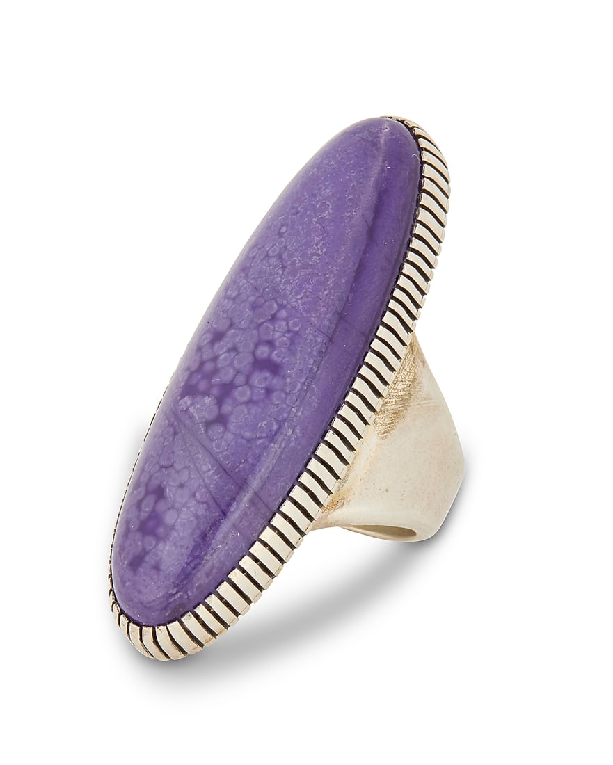 A Herman Vandever Navajo sterling silver and sugilite ring: A Herman Vandever Navajo sterling silver and sugilite ring Herman Vandever (b. 1964, Dine) Late 20th/21st century Etched signature verso Featuring a large sterling silver ring with an oval set purple